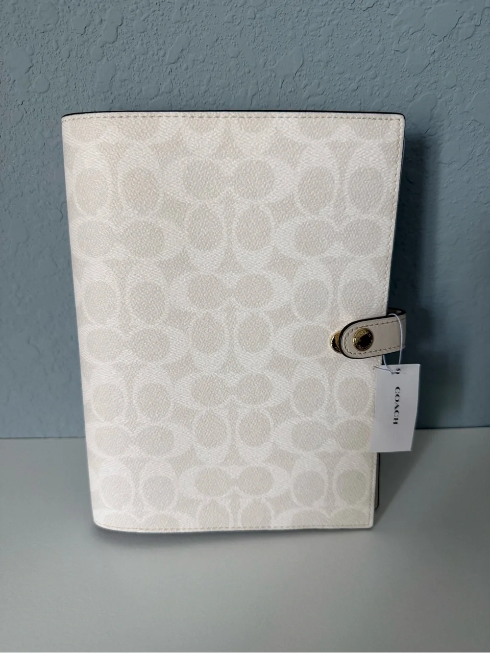 Brand new white coach notebook.